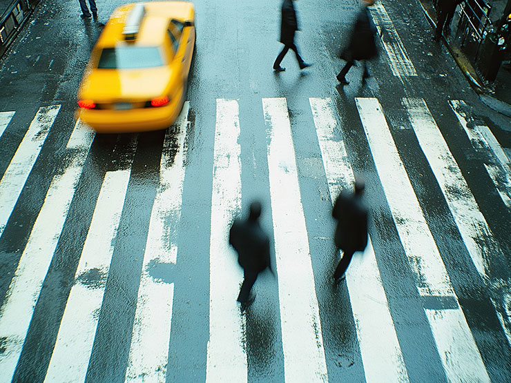 Busy city crosswalk with taxis and pedestrians, illustrating jaywalking and pedestrian accident risks in NYC