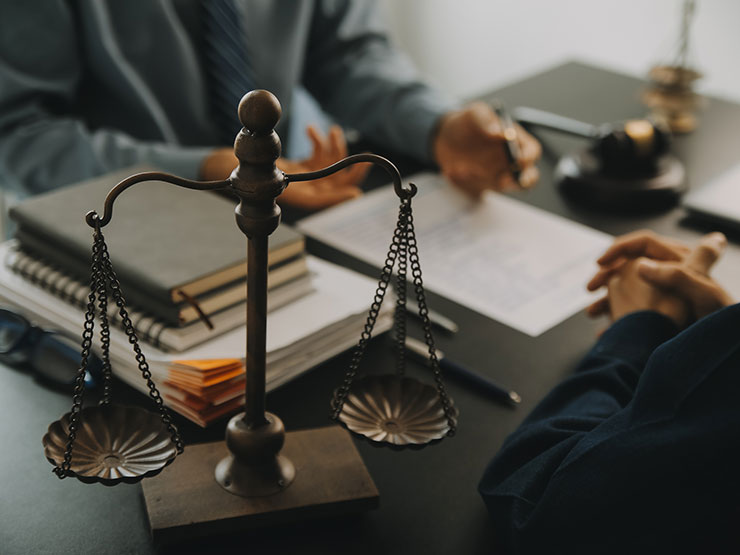 Attorney presenting legal documents to a client, representing a consultation after a NYC pedestrian accident