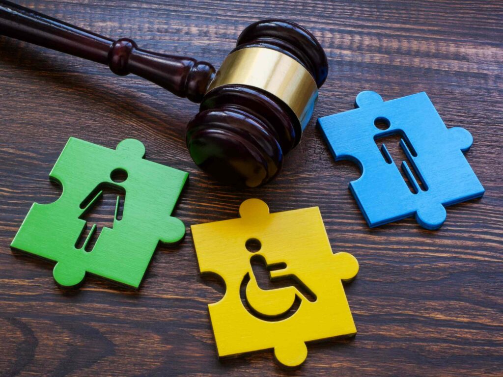 Legal gavel alongside puzzle pieces representing gender and disability rights, illustrating complex cases handled by a New York City employment lawyer.