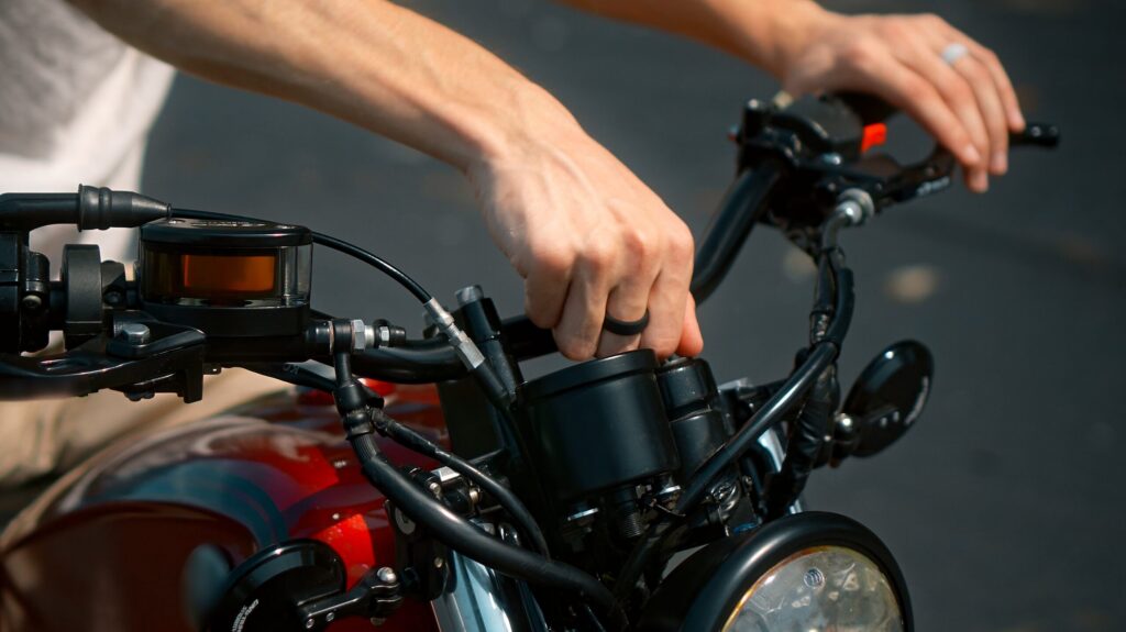 Close-up of a rider’s hands on motorcycle handlebars in Nueva York, representing the unique freedom of riding and the need for protection from a New York City motorcycle accident lawyer.