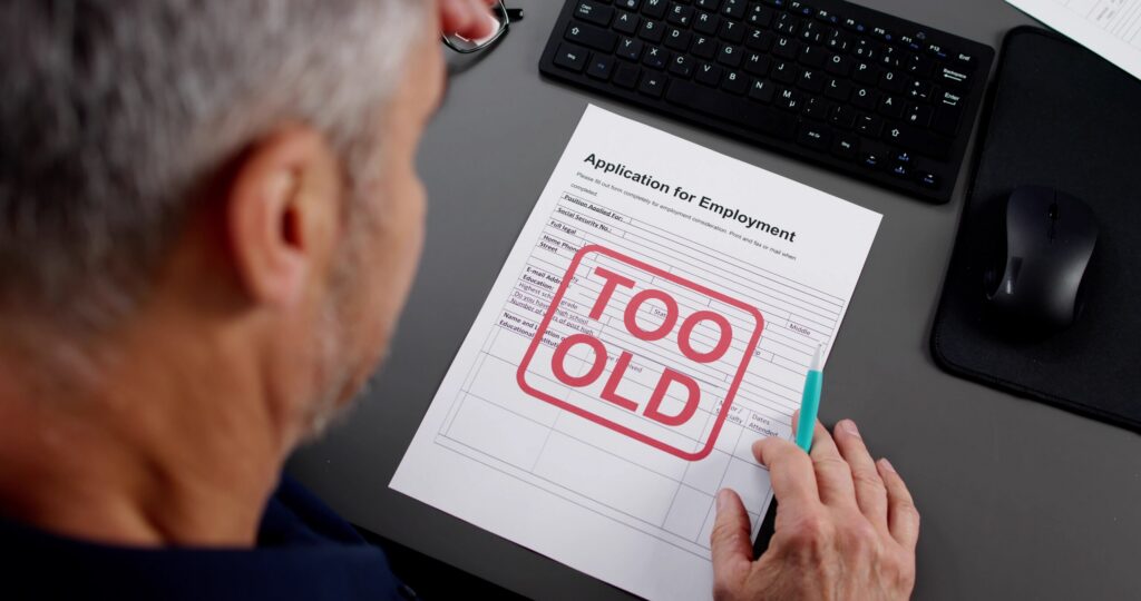Employment application in New York City stamped "Too Old," illustrating age discrimination in the workplace.