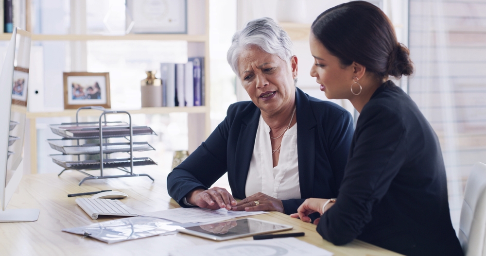 Old woman, meeting and lawyer with document in office for planning, debt settlement and legal guidance. Senior person, attorney and paperwork on retirement fund, asset protection and will information
