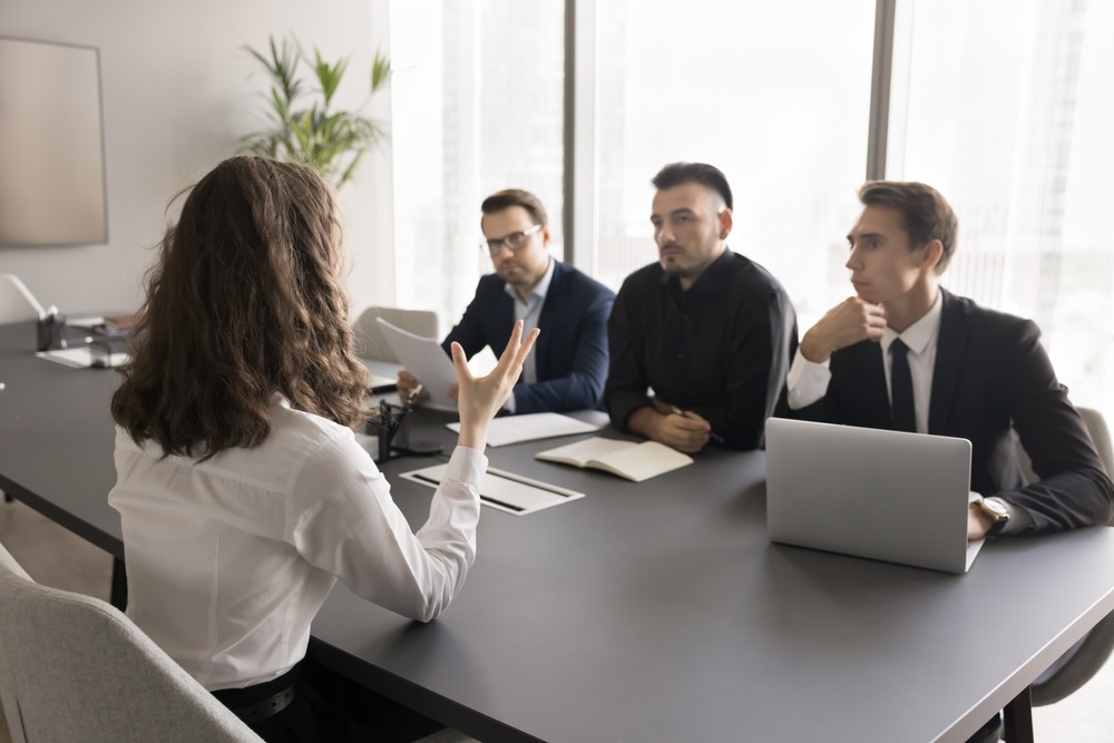 San Francisco gender discrimination lawyer concept showing woman outnumbered by male colleagues during meeting